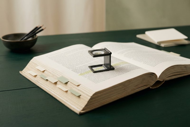 An indexed dossier with a loupe